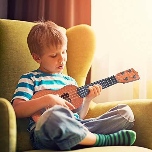 Child sitting on a chair playing a ukulele