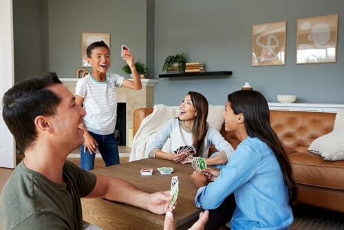 Family enjoying a card game in the living room.